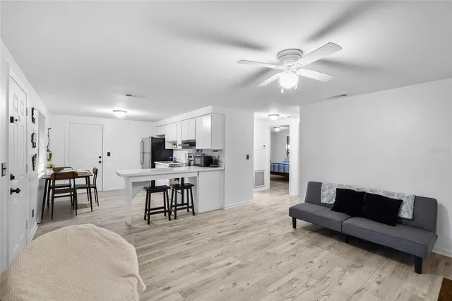 a living room with furniture and kitchen view