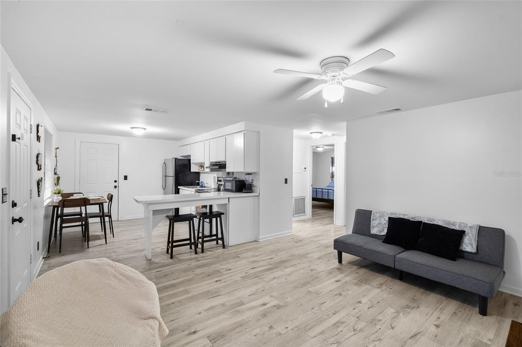 1220 East 142nd Avenue Tampa, FL 33613 - Photo 8 of 36 a living room with furniture and kitchen view