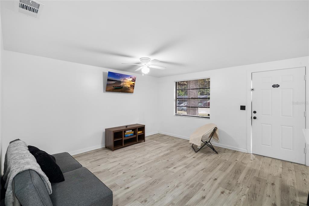 1220 East 142nd Avenue Tampa, FL 33613 - Photo 9 of 36 a bedroom with a bed and wooden floor