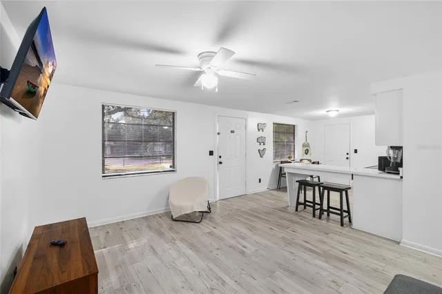 a view of a room with furniture and wooden floor