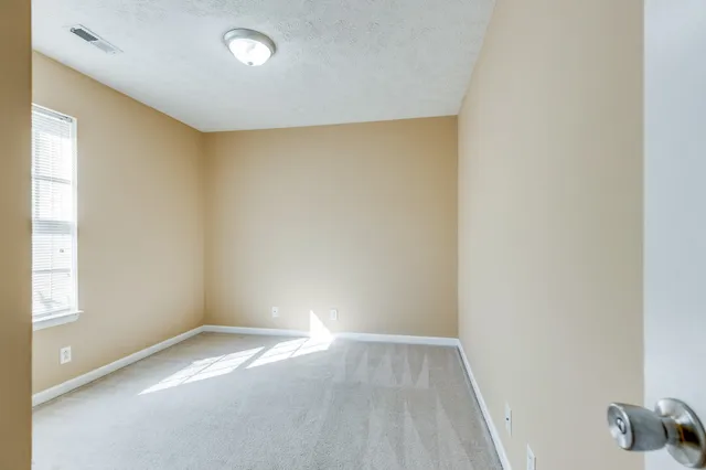 an empty room with a empty space and a window