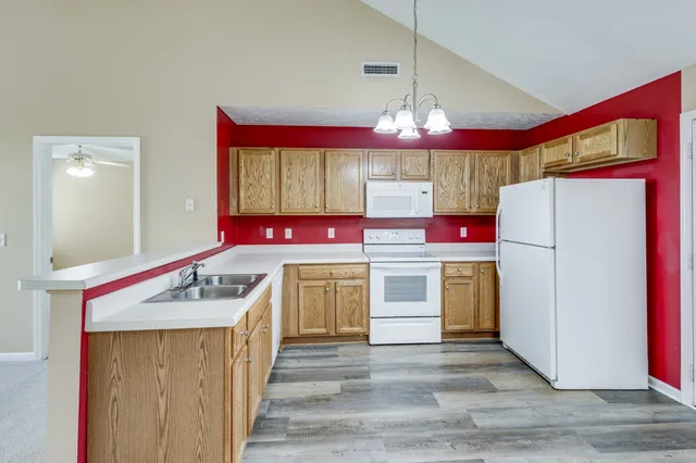 a kitchen with stainless steel appliances granite countertop a stove a refrigerator and a stove