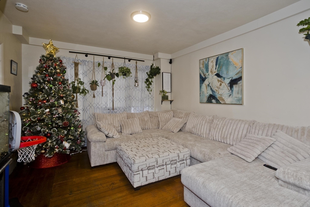 298 Oakland Street Springfield, MA 01108 - Photo 14 of 38 a living room with furniture and a couch