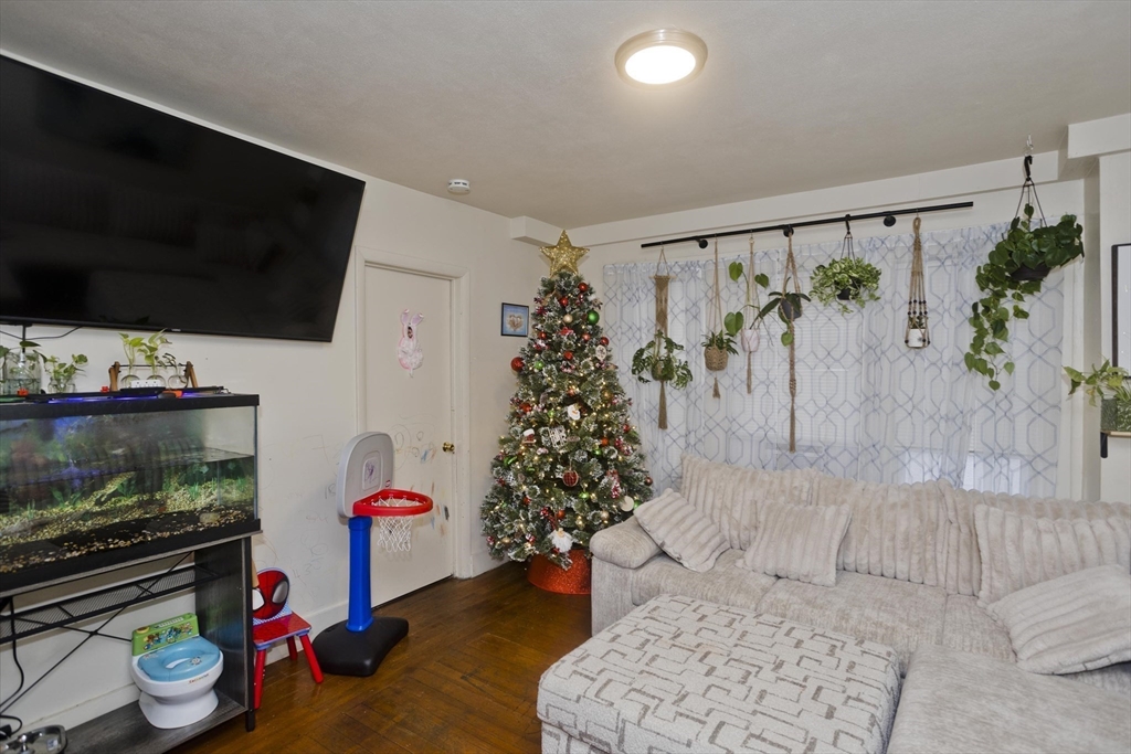 298 Oakland Street Springfield, MA 01108 - Photo 15 of 38 a living room with furniture and a flat screen tv