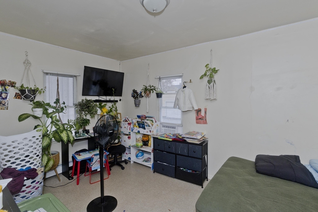 298 Oakland Street Springfield, MA 01108 - Photo 17 of 38 a living room with furniture and a flat screen tv