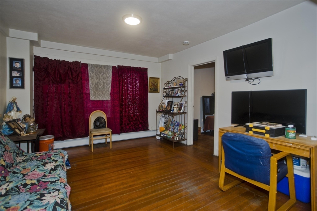 298 Oakland Street Springfield, MA 01108 - Photo 18 of 38 a living room with furniture and a flat screen tv