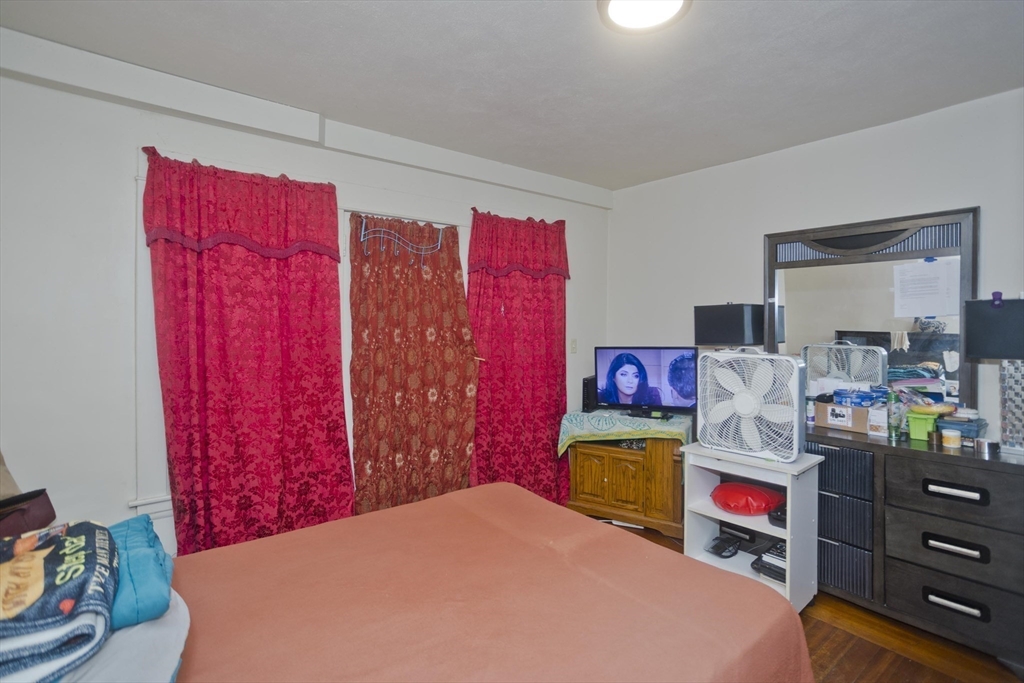 298 Oakland Street Springfield, MA 01108 - Photo 19 of 38 a bedroom with a bed and dresser