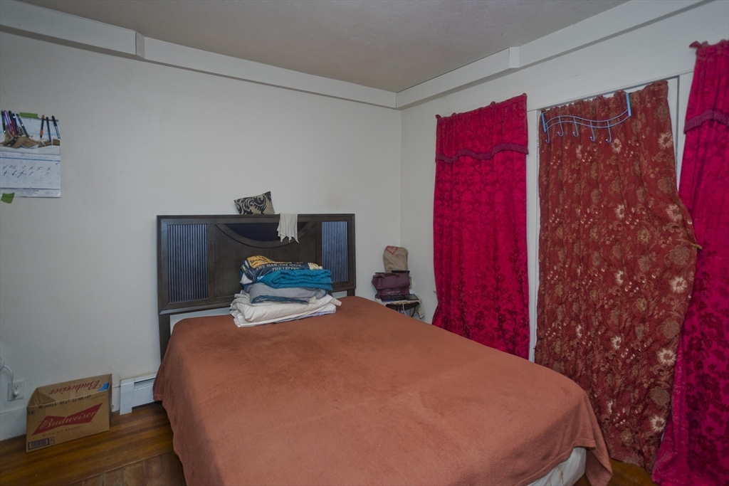 298 Oakland Street Springfield, MA 01108 - Photo 20 of 38 a bedroom with a bed and a chair