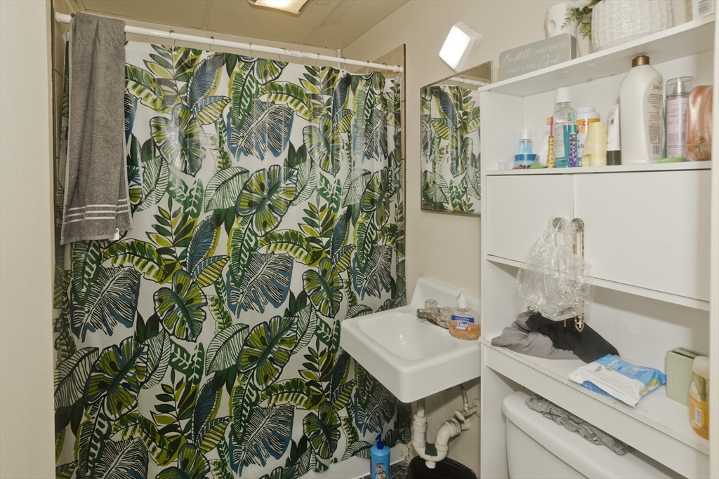 298 Oakland Street Springfield, MA 01108 - Photo 21 of 38 a bathroom with a sink and a mirror