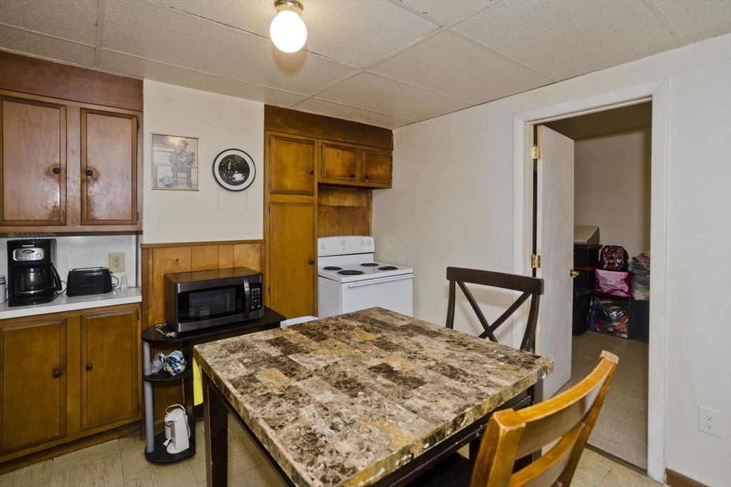 298 Oakland Street Springfield, MA 01108 - Photo 25 of 38 a kitchen with a table and chairs in it