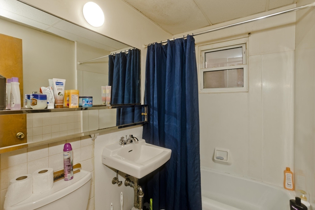 298 Oakland Street Springfield, MA 01108 - Photo 27 of 38 a bathroom with a sink and a mirror