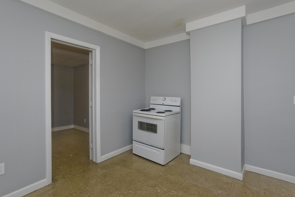 298 Oakland Street Springfield, MA 01108 - Photo 8 of 38 a kitchen with a stove and a microwave