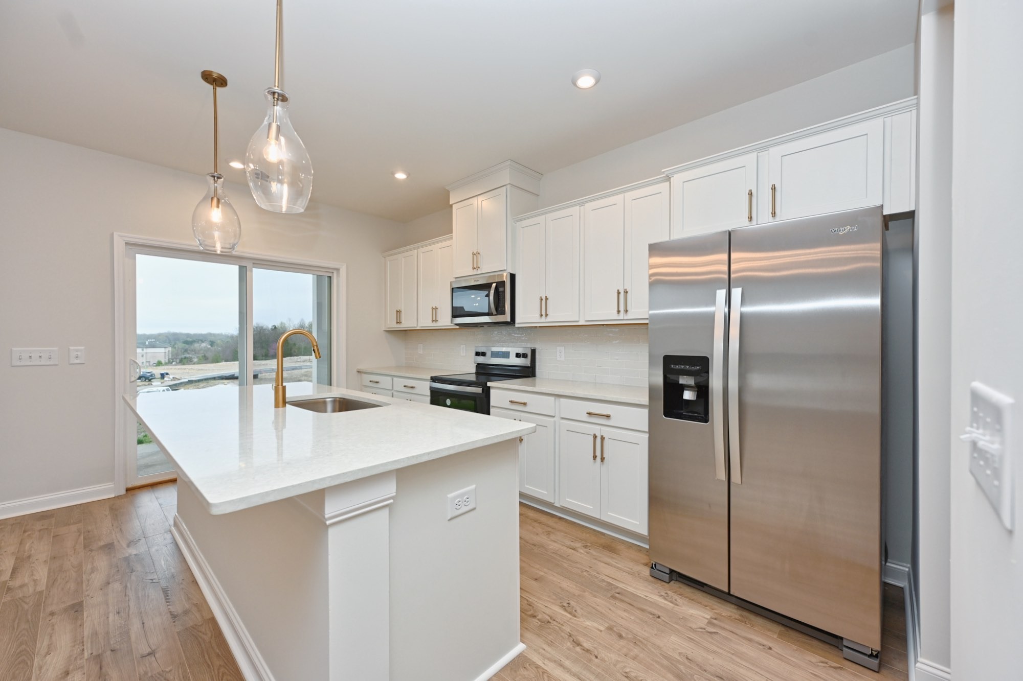 2305 Juneau Lane Columbia, TN 38401 - Photo 15 of 50 a kitchen with kitchen island white cabinets and stainless steel appliances