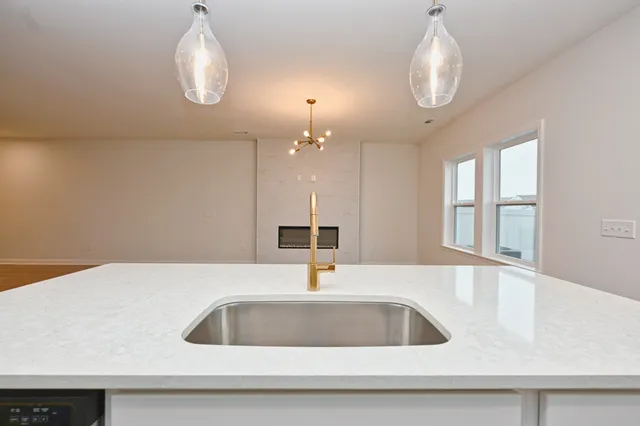 a kitchen with a sink cabinets and a large window