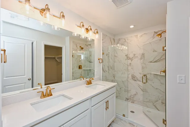 a bathroom with a shower sink and mirror