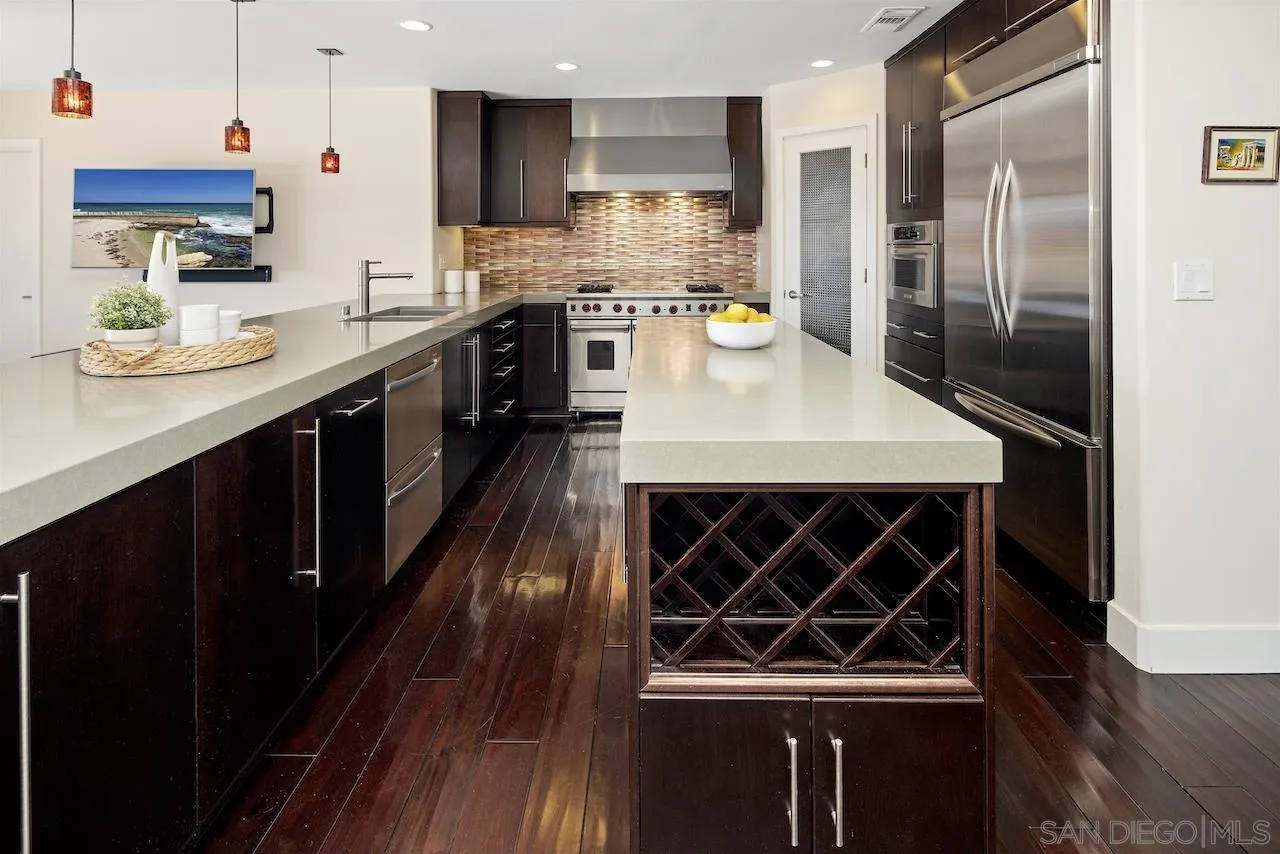 5510 Moonlight Lane La Jolla, CA 92037 - Photo 12 of 35 a kitchen with stainless steel appliances granite countertop a sink stove and refrigerator