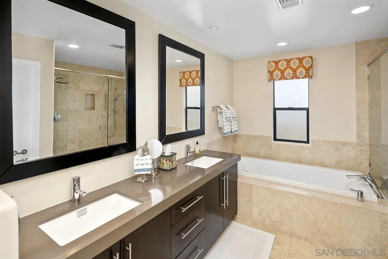 5510 Moonlight Lane La Jolla, CA 92037 - Photo 8 of 35 a bathroom with double vanity sinks a large mirror and a bathtub