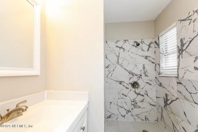 a bathroom with a bathtub and shower