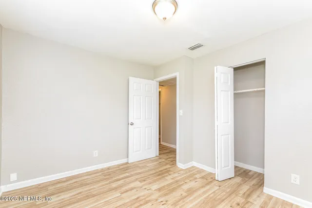 a view of a room with wooden floor