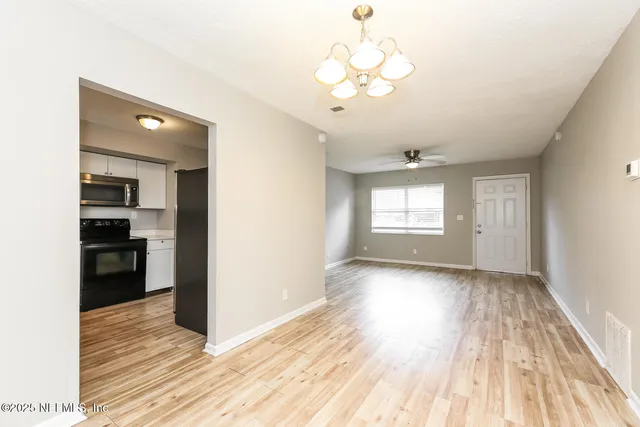 a view of a room with wooden floor and staircase