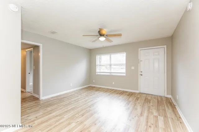 wooden floor in an empty room with a window