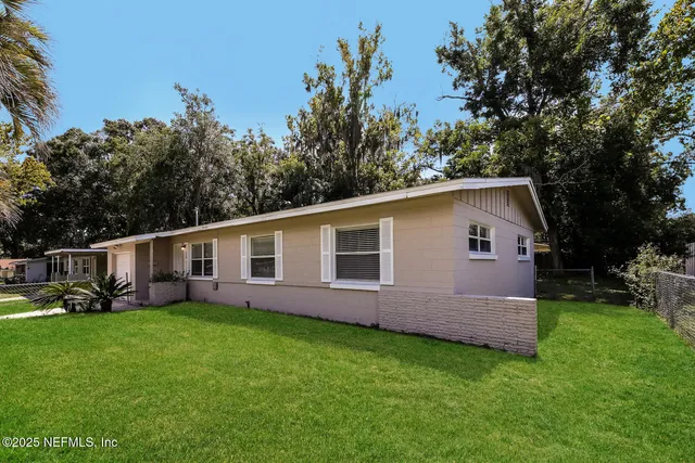 a front view of house with yard and green space