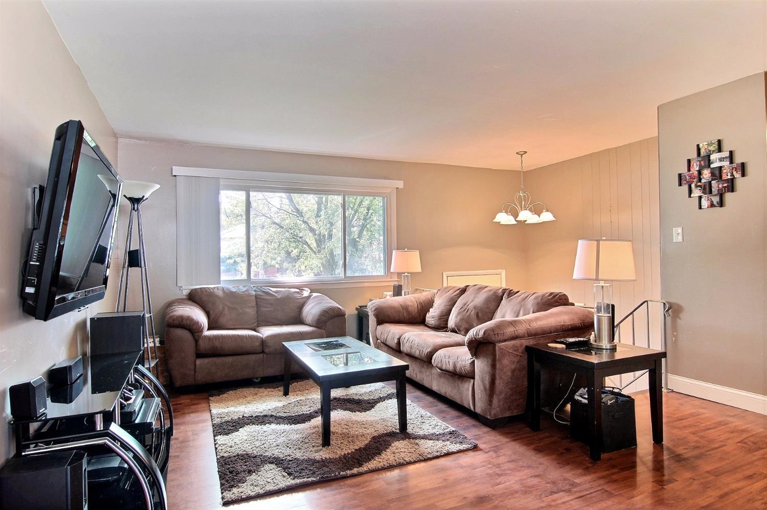 7829 Whitcomb Street Merrillville, IN 46410 - Photo 4 of 10 a living room with furniture a window and a flat screen tv