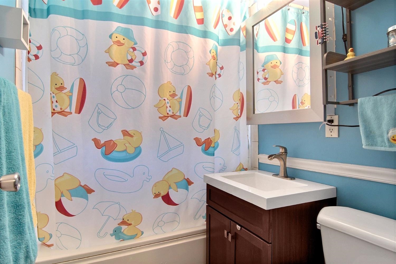 7829 Whitcomb Street Merrillville, IN 46410 - Photo 10 of 10 a bathroom with a sink a mirror and painting on the wall