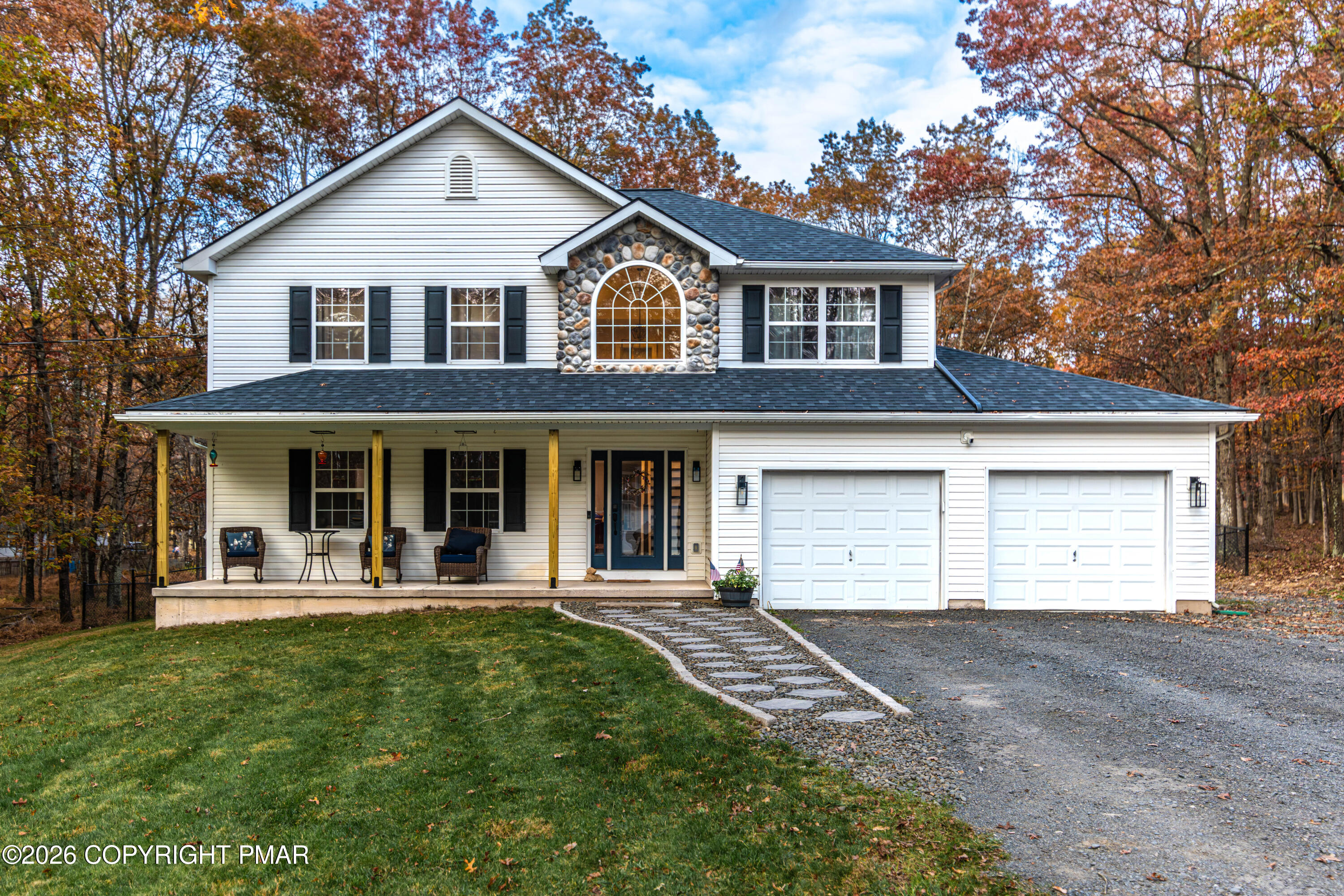 a front view of a house with a yard and garage
