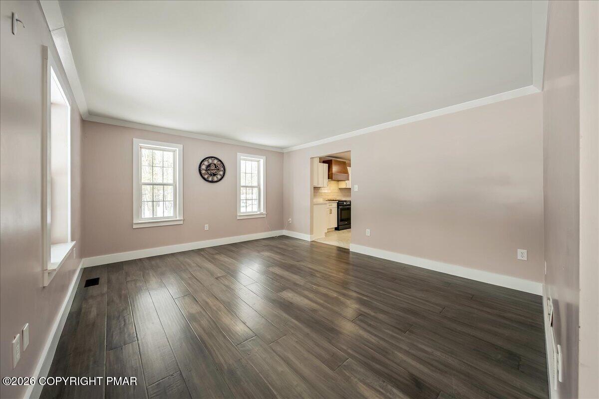 140 Alcott Lane Effort, PA 18330 - Photo 12 of 82 an empty room with wooden floor and windows
