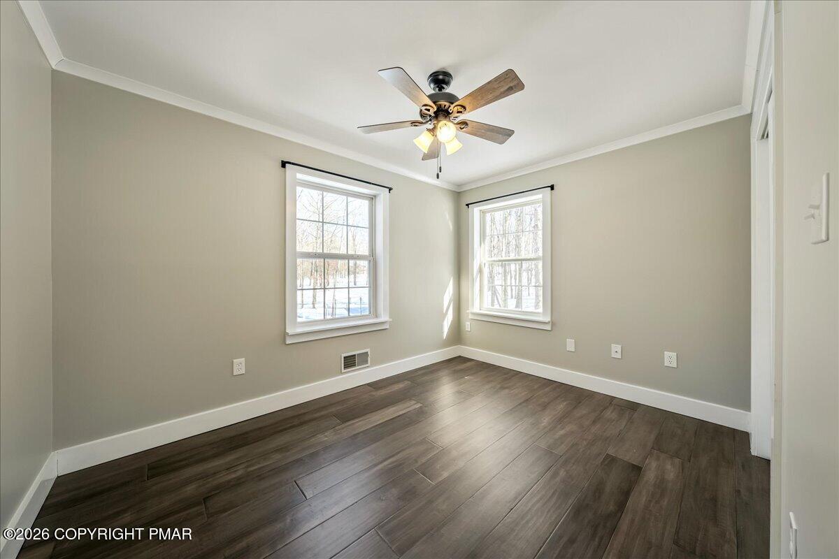 140 Alcott Lane Effort, PA 18330 - Photo 31 of 76 a view of an empty room with wooden floor and a window