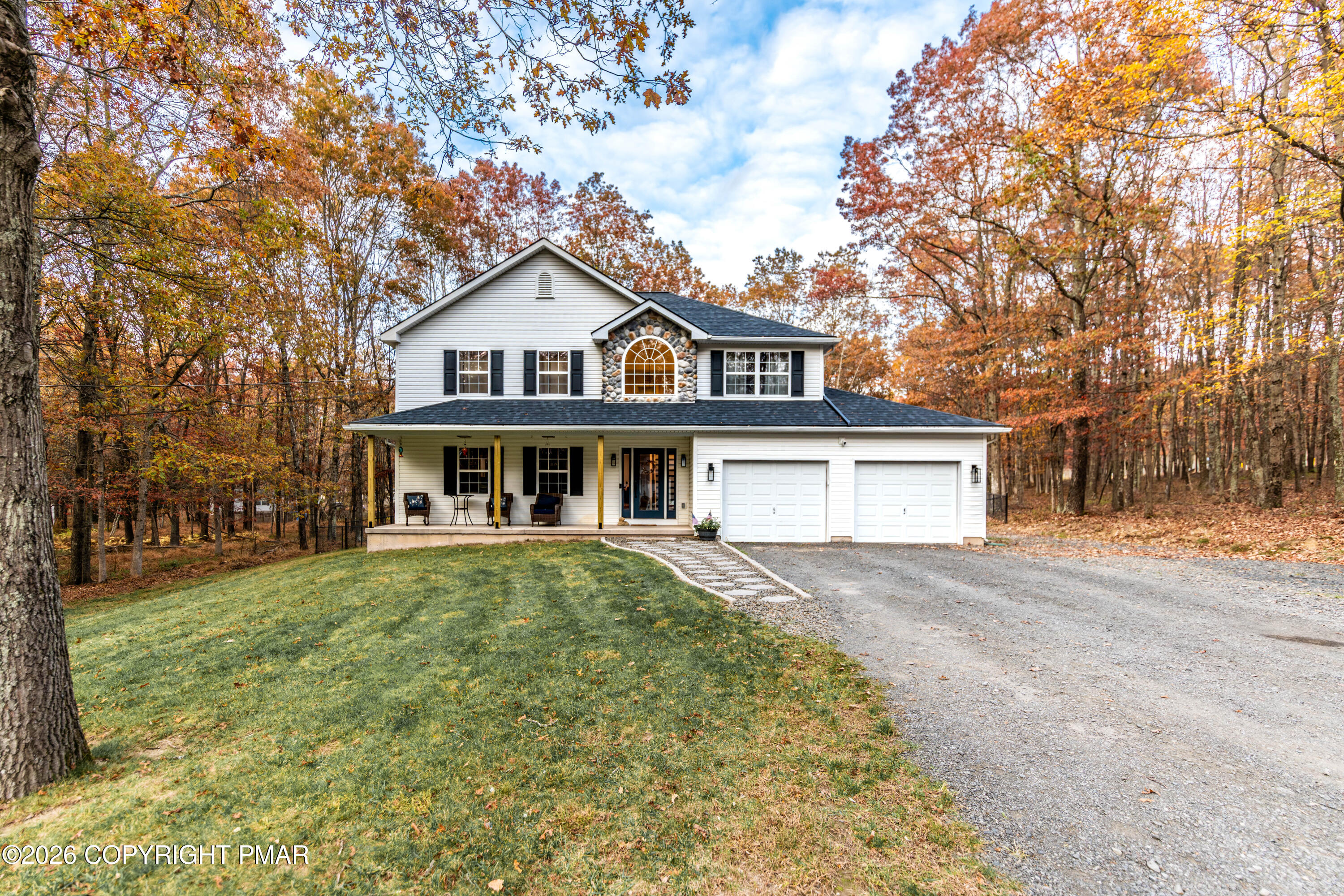 140 Alcott Lane Effort, PA 18330 - Photo 4 of 76 a front view of a house with a garden and trees