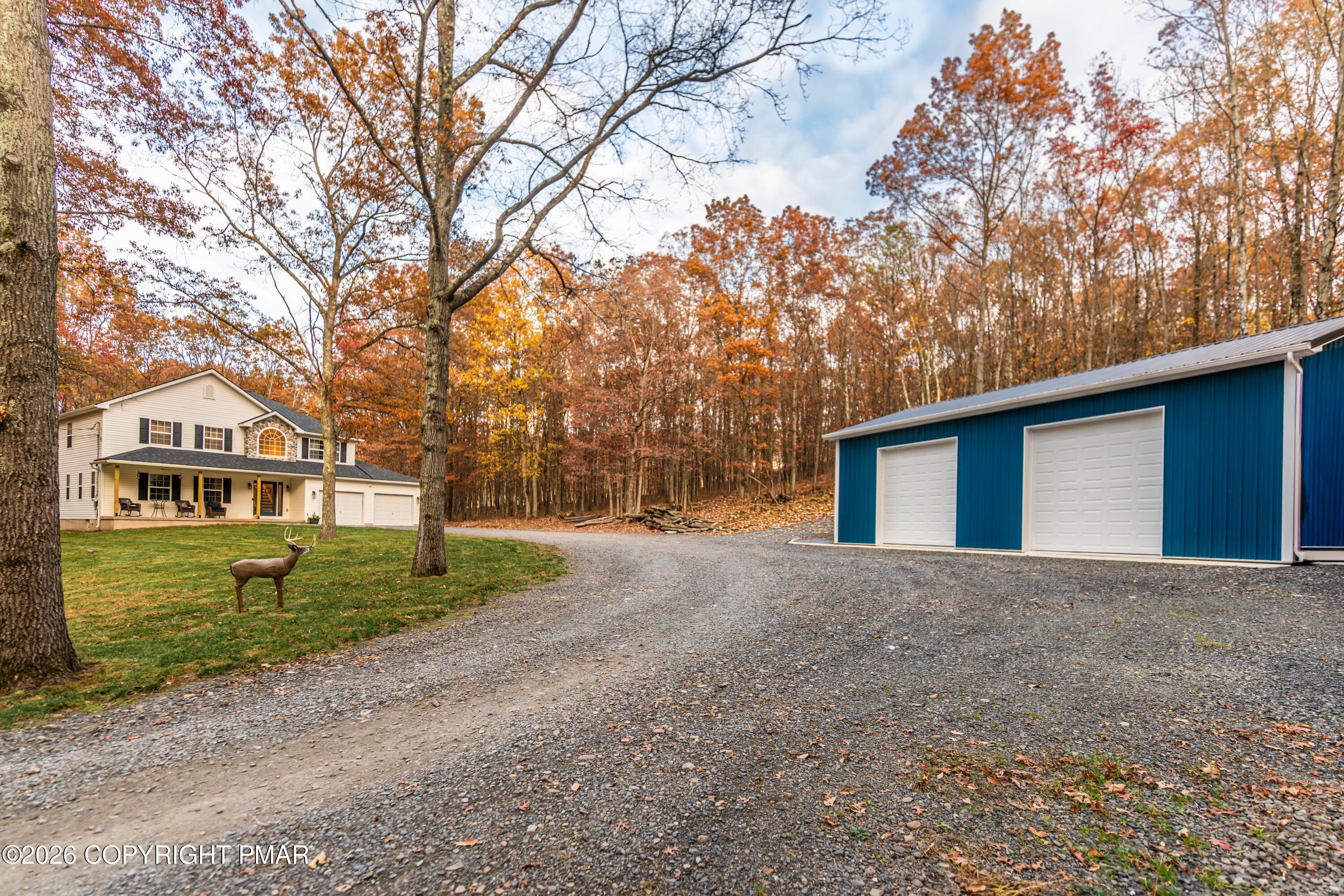 140 Alcott Lane Effort, PA 18330 - Photo 65 of 76 a front view of a house with a yard and garage