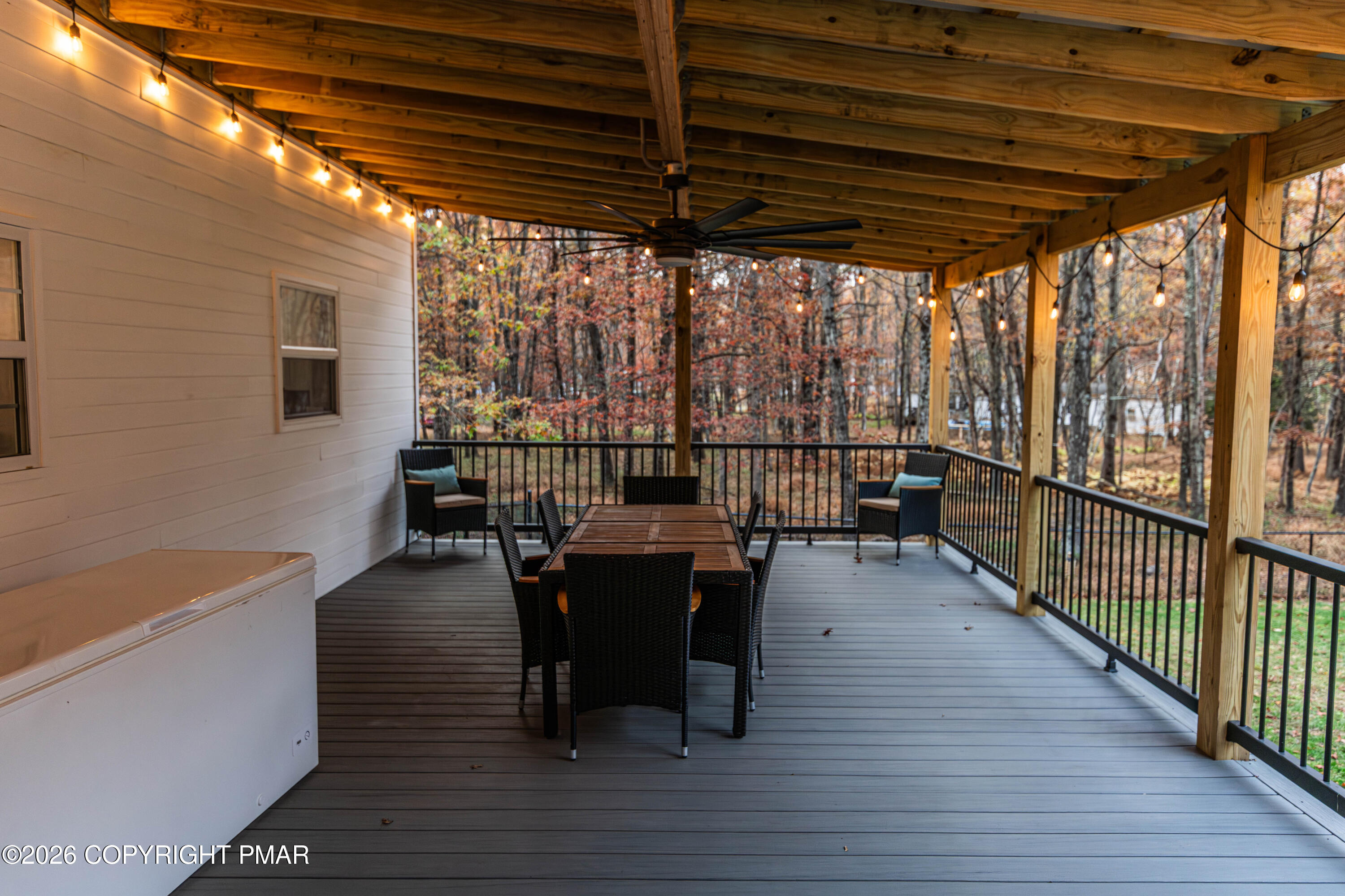 140 Alcott Lane Effort, PA 18330 - Photo 73 of 76 a view of a patio with dining table and chairs with wooden floor