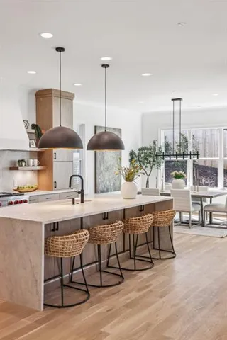 a large kitchen with stainless steel appliances a lot of counter space and a wooden floors