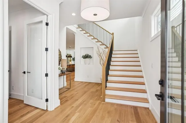 a view of a hallway with wooden floor and entryway