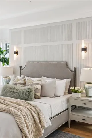 a white bath tub sitting in a bathroom next to a window