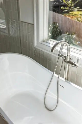 a bathroom with a granite countertop sink a toilet and shower