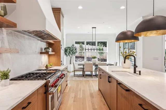 a kitchen with stainless steel appliances granite countertop a refrigerator and a cabinets