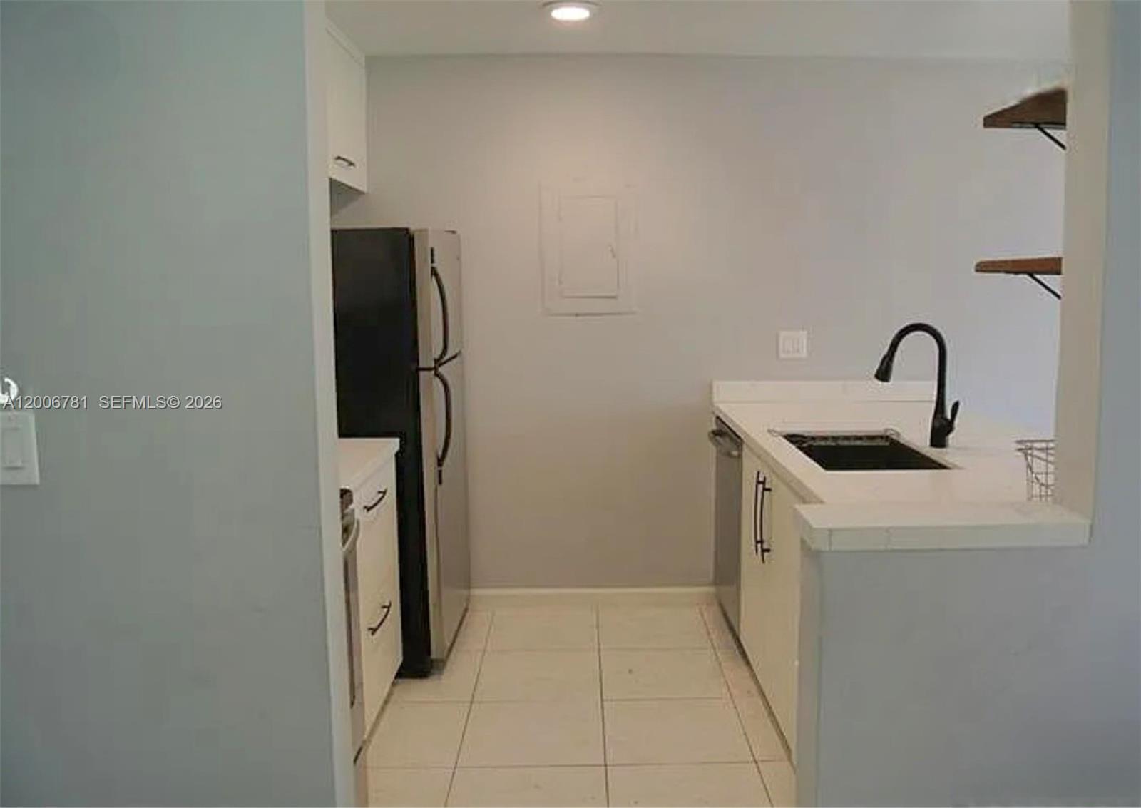 2160 Southwest 16th Avenue, Unit 417 Miami, FL 33145 - Photo 11 of 24 a kitchen with a sink and refrigerator