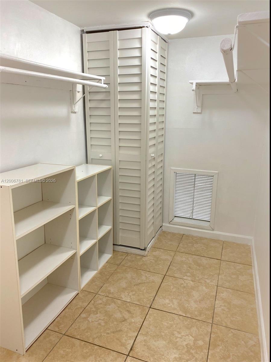 2160 Southwest 16th Avenue, Unit 417 Miami, FL 33145 - Photo 14 of 24 a view of walk in closet with empty racks