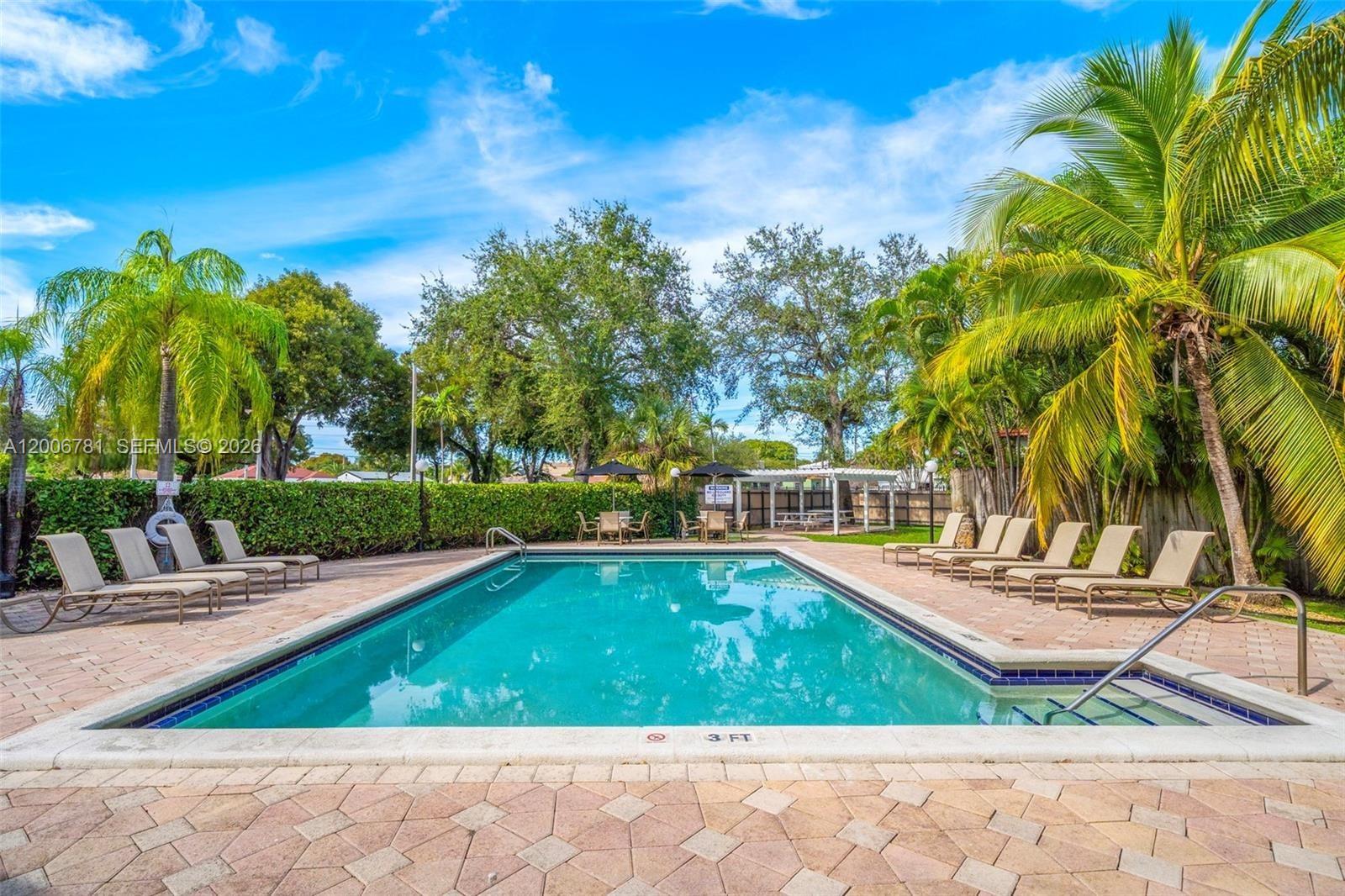 2160 Southwest 16th Avenue, Unit 417 Miami, FL 33145 - Photo 17 of 24 a view of a swimming pool with a patio