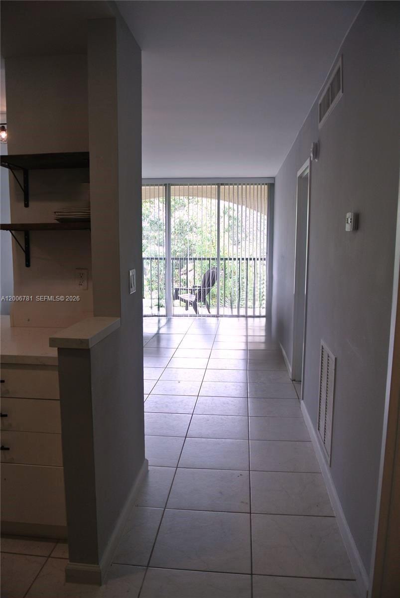 2160 Southwest 16th Avenue, Unit 417 Miami, FL 33145 - Photo 5 of 24 a hallway with a wooden floor and a rug