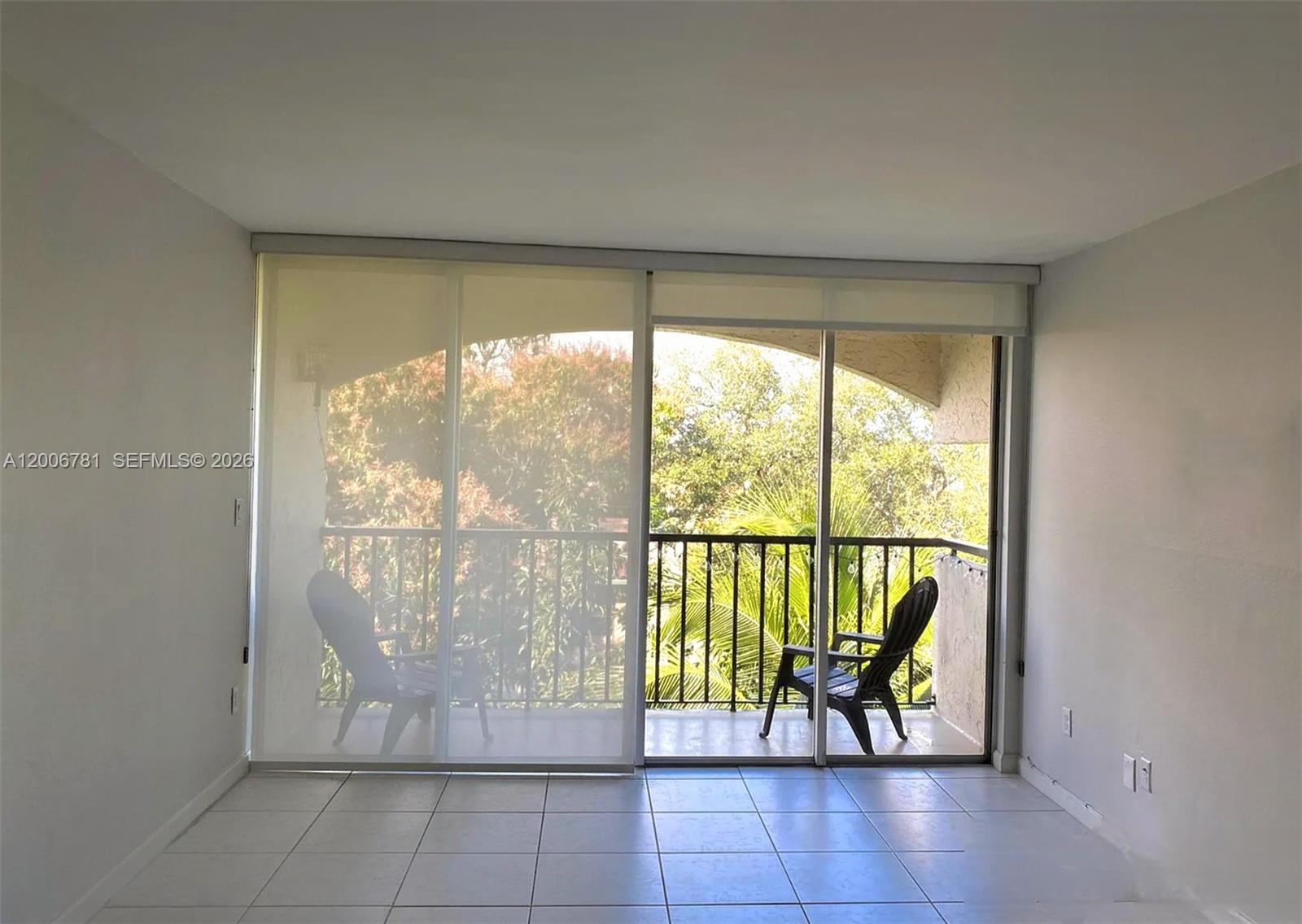 2160 Southwest 16th Avenue, Unit 417 Miami, FL 33145 - Photo 6 of 24 an empty room with sliding door and mountain view