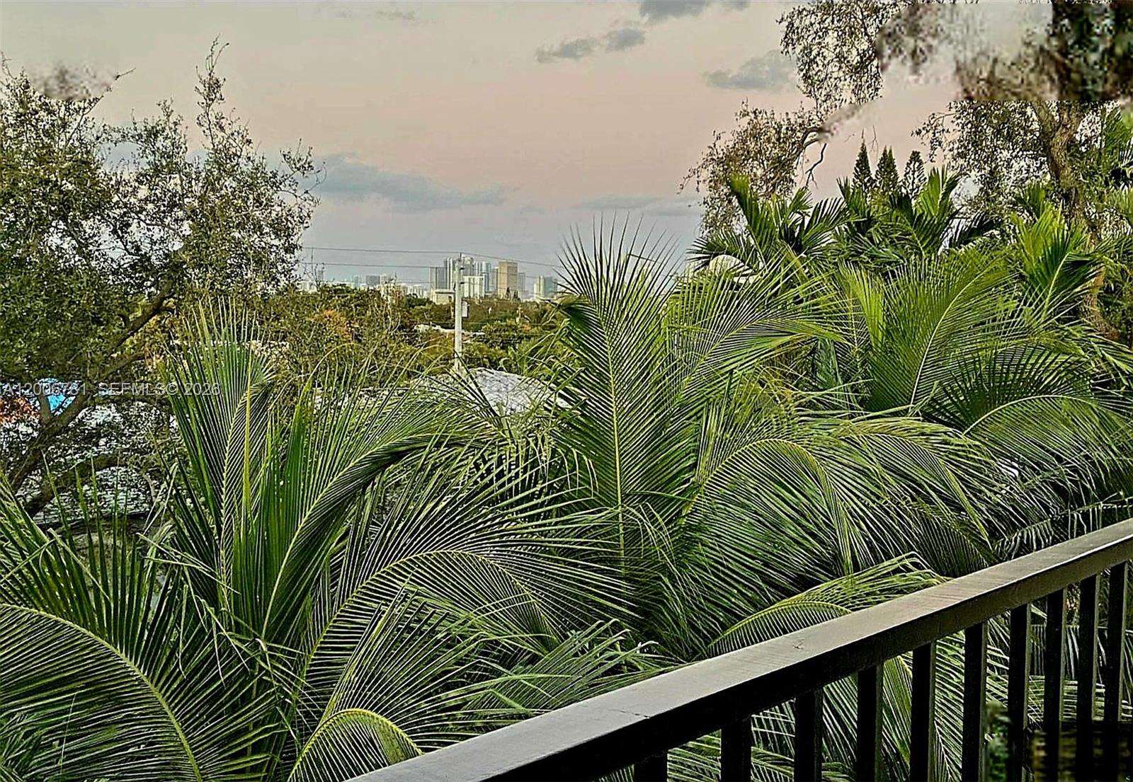 2160 Southwest 16th Avenue, Unit 417 Miami, FL 33145 - Photo 8 of 24 a view of a yard with plants and wooden fence