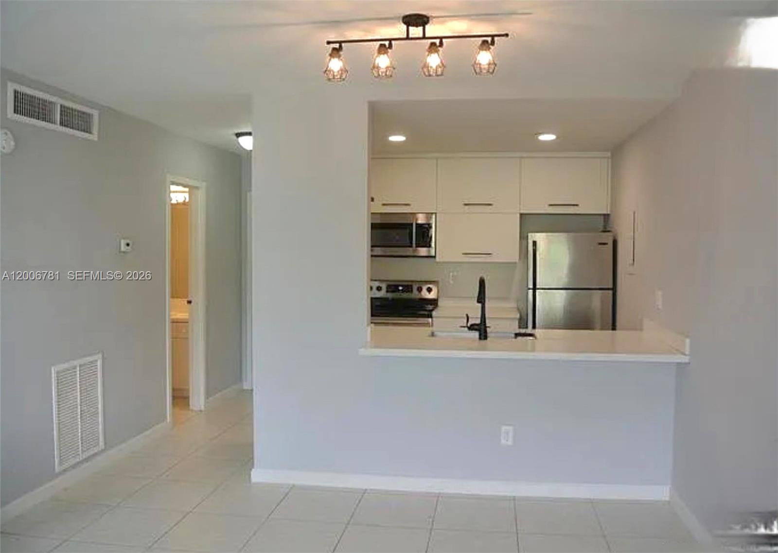 2160 Southwest 16th Avenue, Unit 417 Miami, FL 33145 - Photo 10 of 24 a view of a kitchen with a sink and refrigerator
