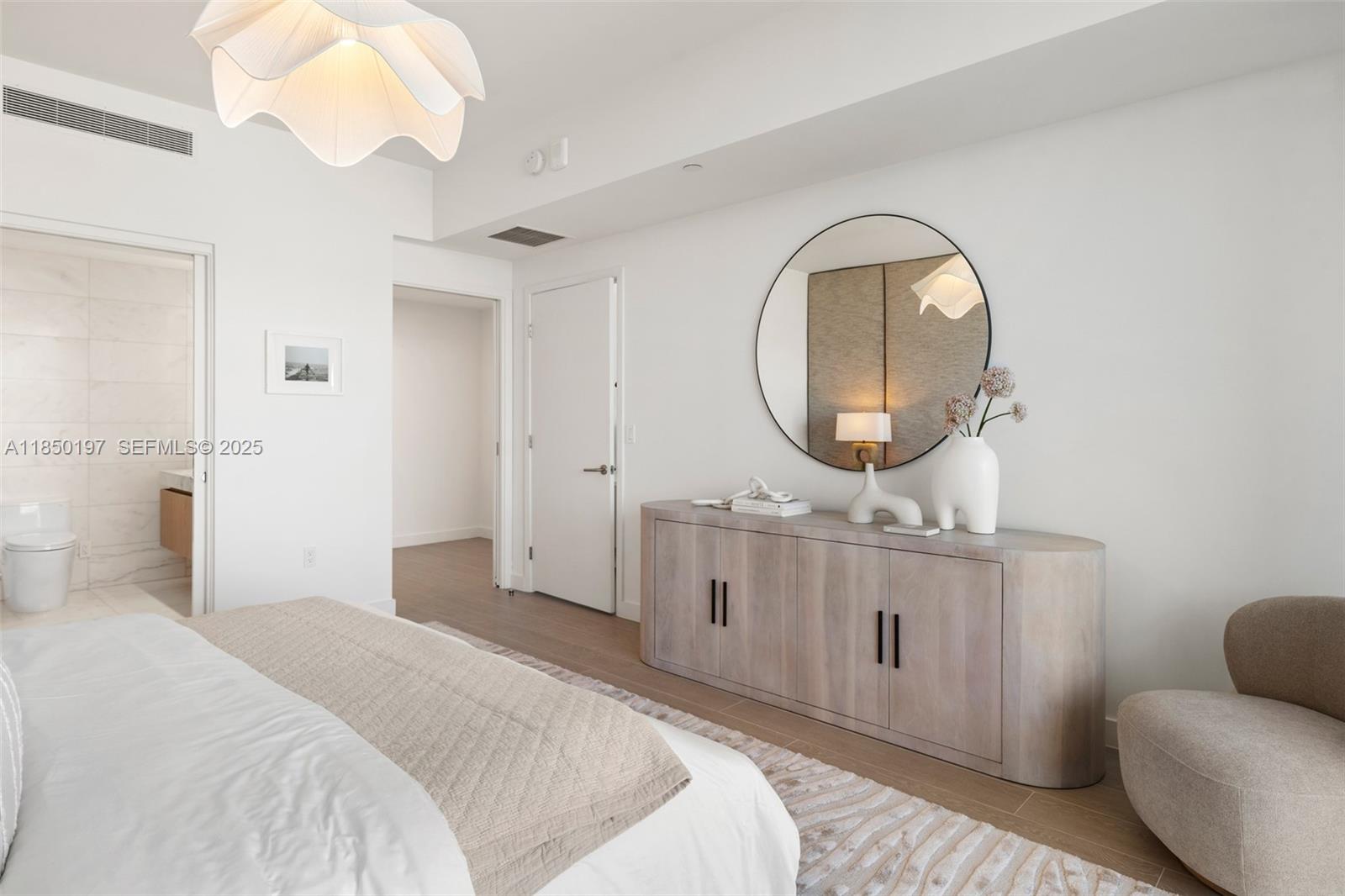 500 Alton Road, Unit 807 Miami Beach, FL 33139 - Photo 14 of 20 a bedroom with bed and a mirror