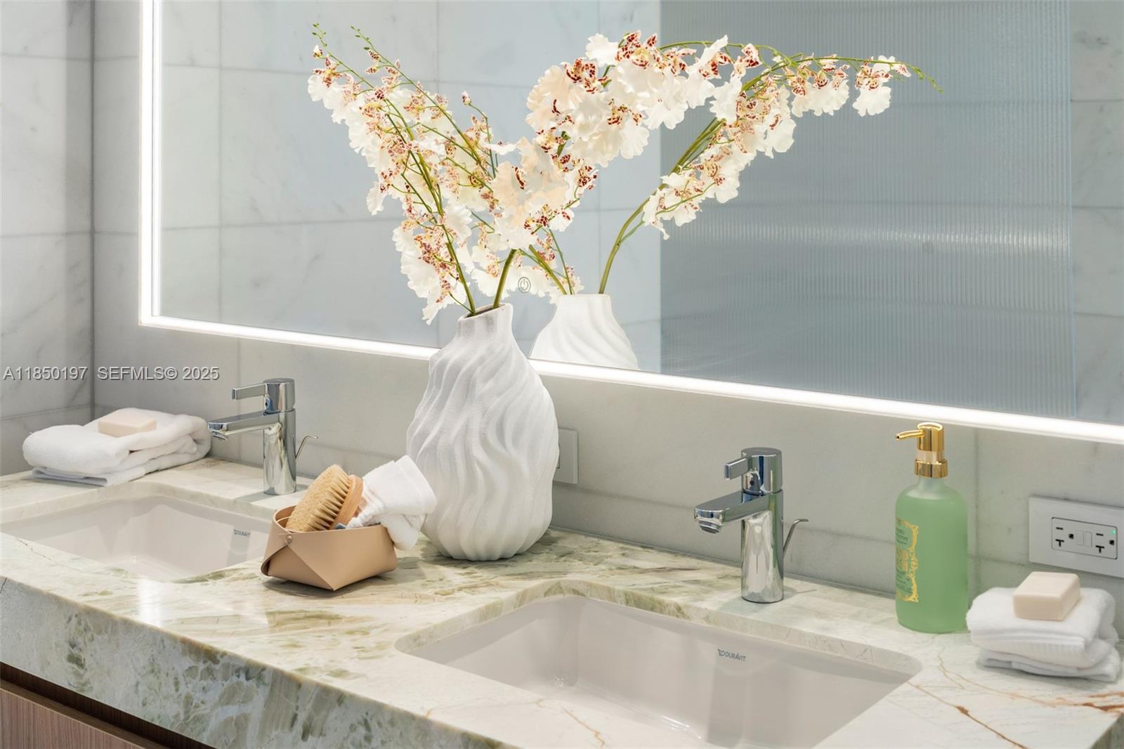500 Alton Road, Unit 807 Miami Beach, FL 33139 - Photo 16 of 20 a bathroom with a sink a mirror and a shower