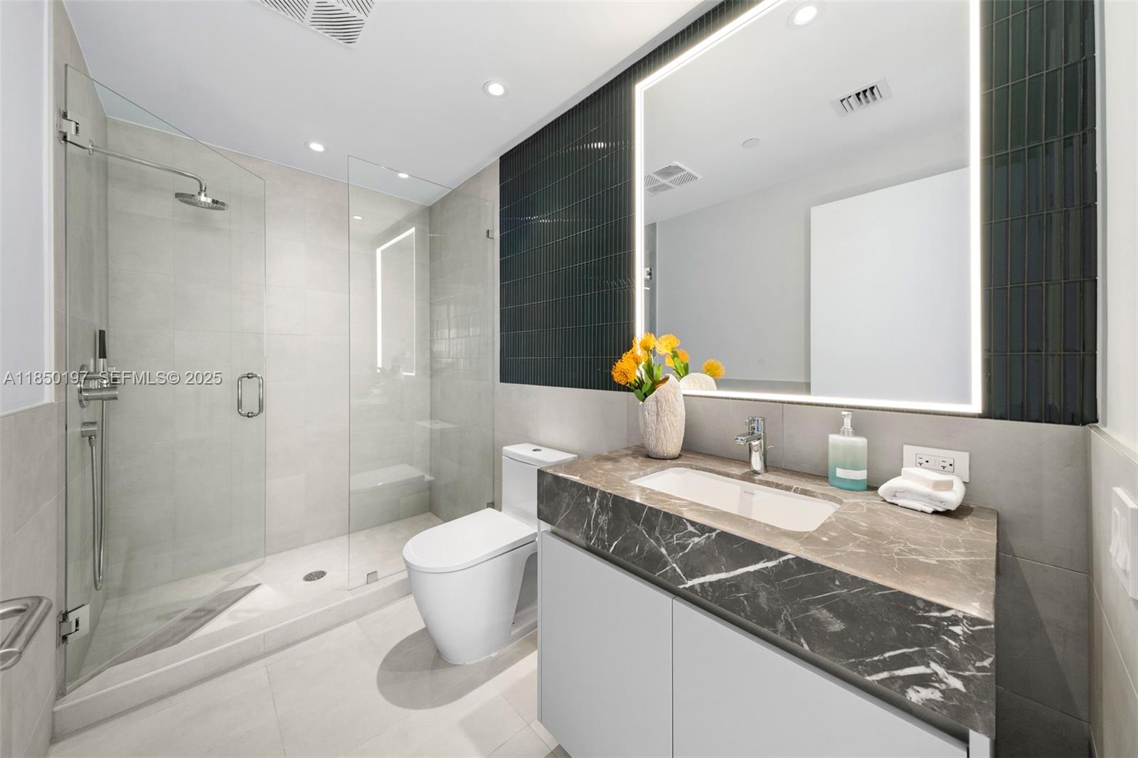 500 Alton Road, Unit 807 Miami Beach, FL 33139 - Photo 19 of 20 a bathroom with a granite countertop sink a toilet and shower