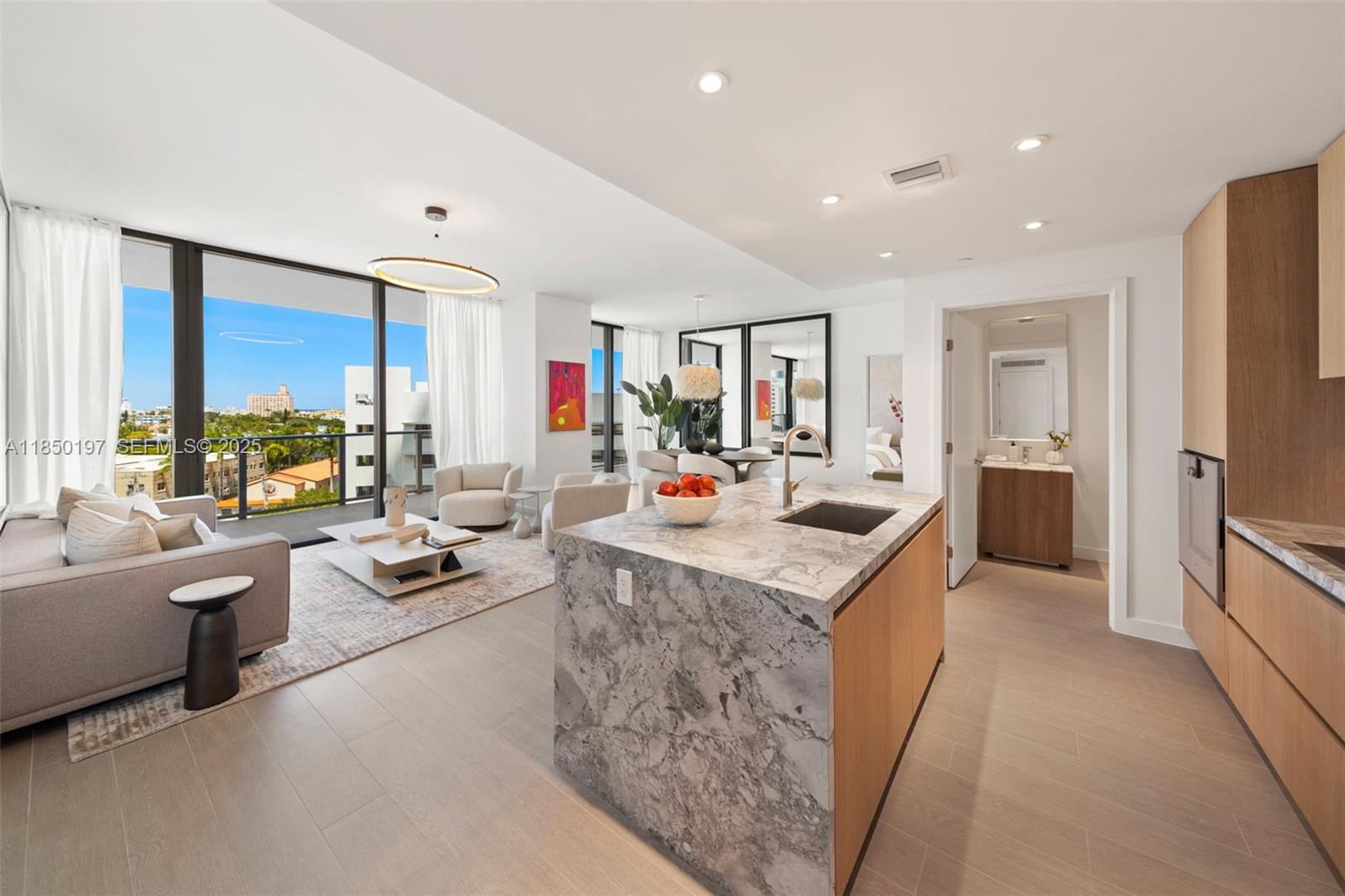500 Alton Road, Unit 807 Miami Beach, FL 33139 - Photo 5 of 20 a large living room with stainless steel appliances granite countertop furniture and a large window